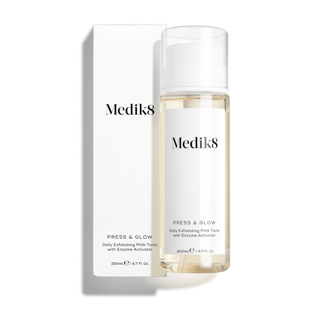 Fľaša tonika Medik8 Press & Glow stojí pred zodpovedajúcim bielym obalom na čistom bielom pozadí. Text na oboch označuje produkt ako 200 ml tonikum na každodenné exfoliovanie s PHA a enzýmovým aktivátorom. 